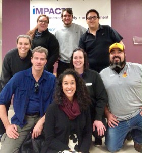 (Front Row: IMPACT Boston Program Coordinator Adriana Li; Middle Row kneeling, from left to right: IMPACT Boston Trainer & Instructor Mike Perry, Turtle Mountain IMPACT Instructor Sara Davis, Turtle Mountain IMPACT Suited Instructor Wes Davis; Back Row, standing, from left to right: IMPACT Boston Director Meg Stone, Turtle Mountain IMPACT Director Shanda Poitra, IMPACT Boston Program Coordinator Ben Comeau, Turtle Mountain IMPACT Suited Instructor James Decoteau)